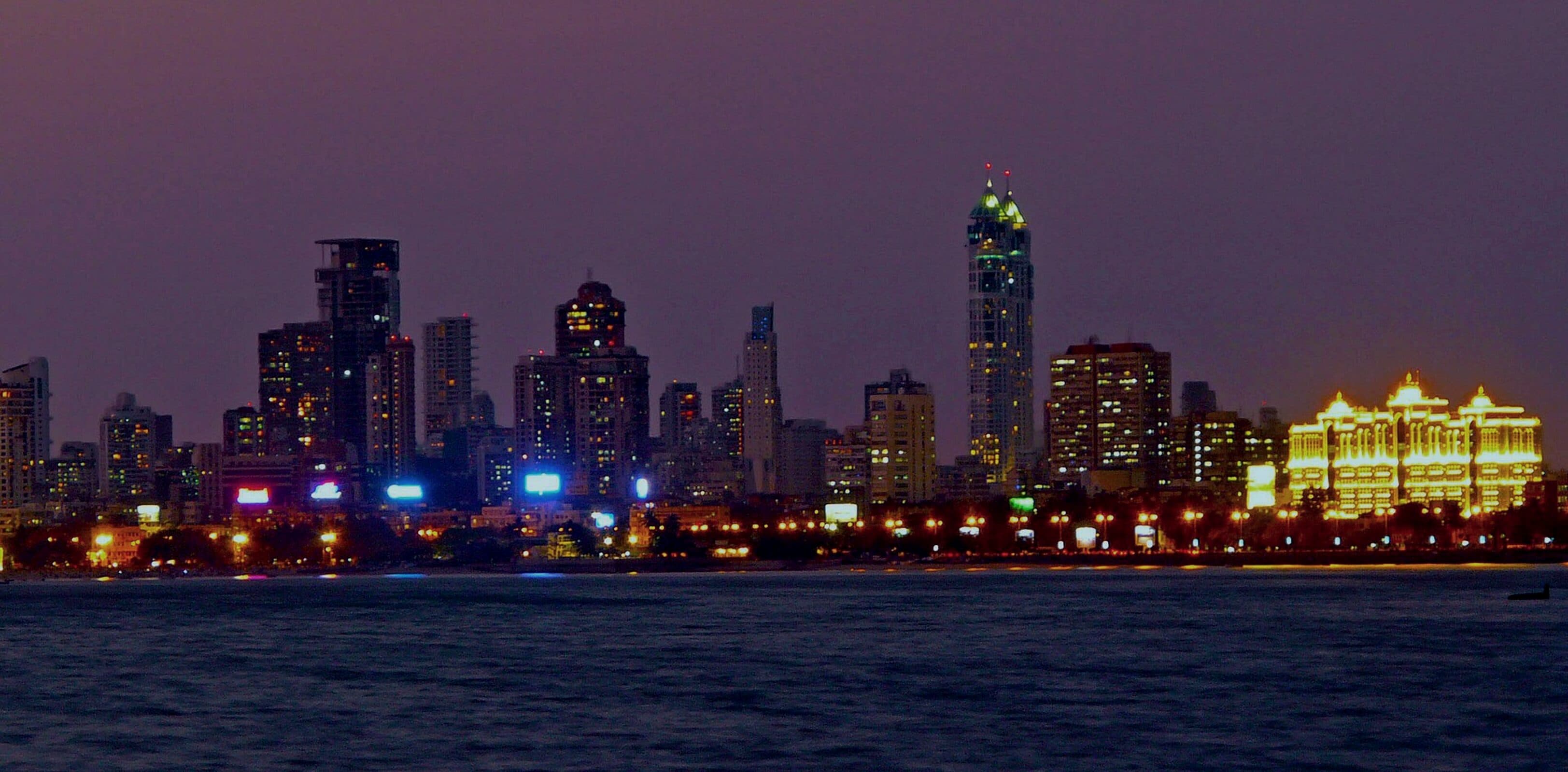 City skyline lit at night across the water
